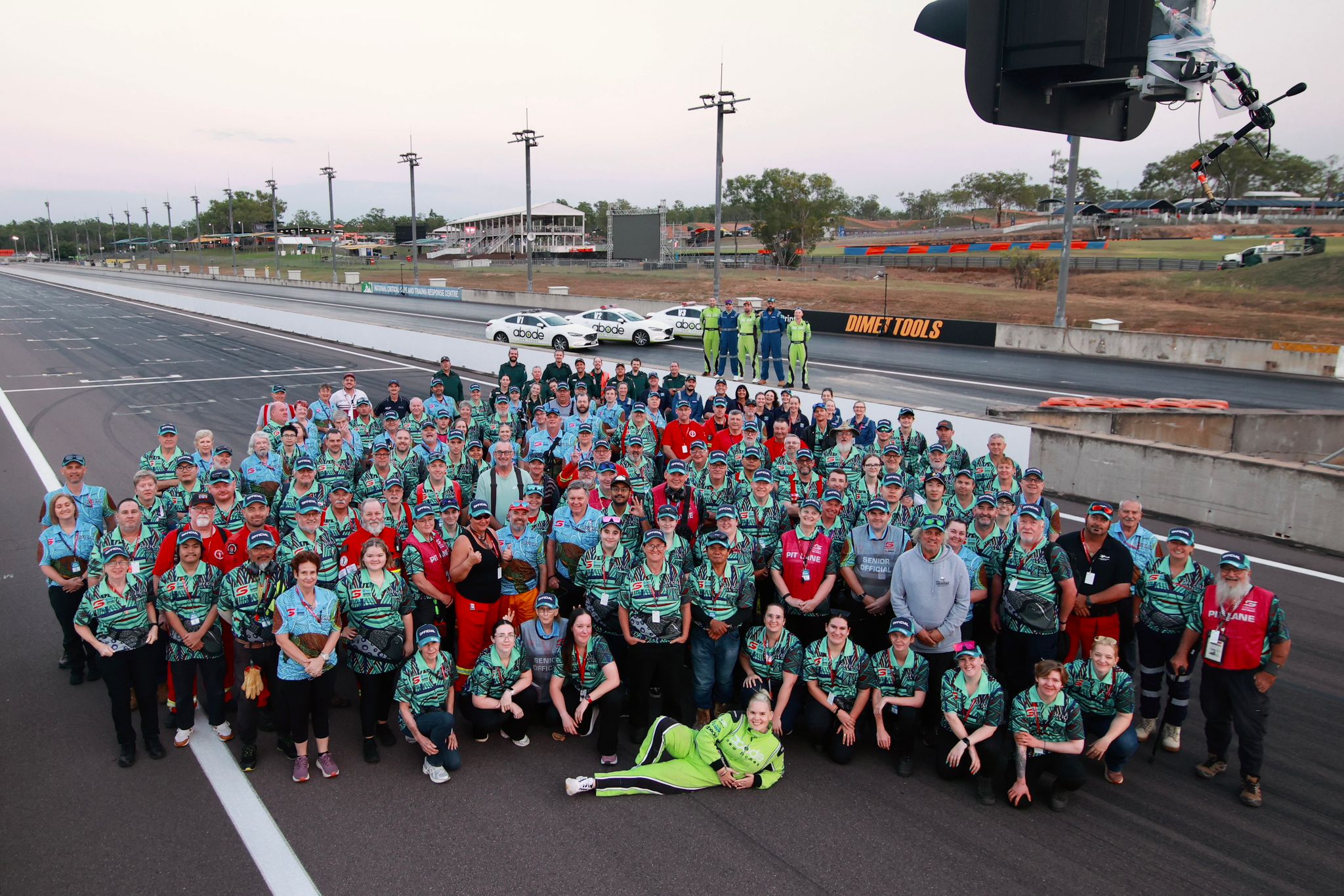 Darwin Supercars volunteers and officials gather for a large group photo on the track at Hidden Valley Raceway.