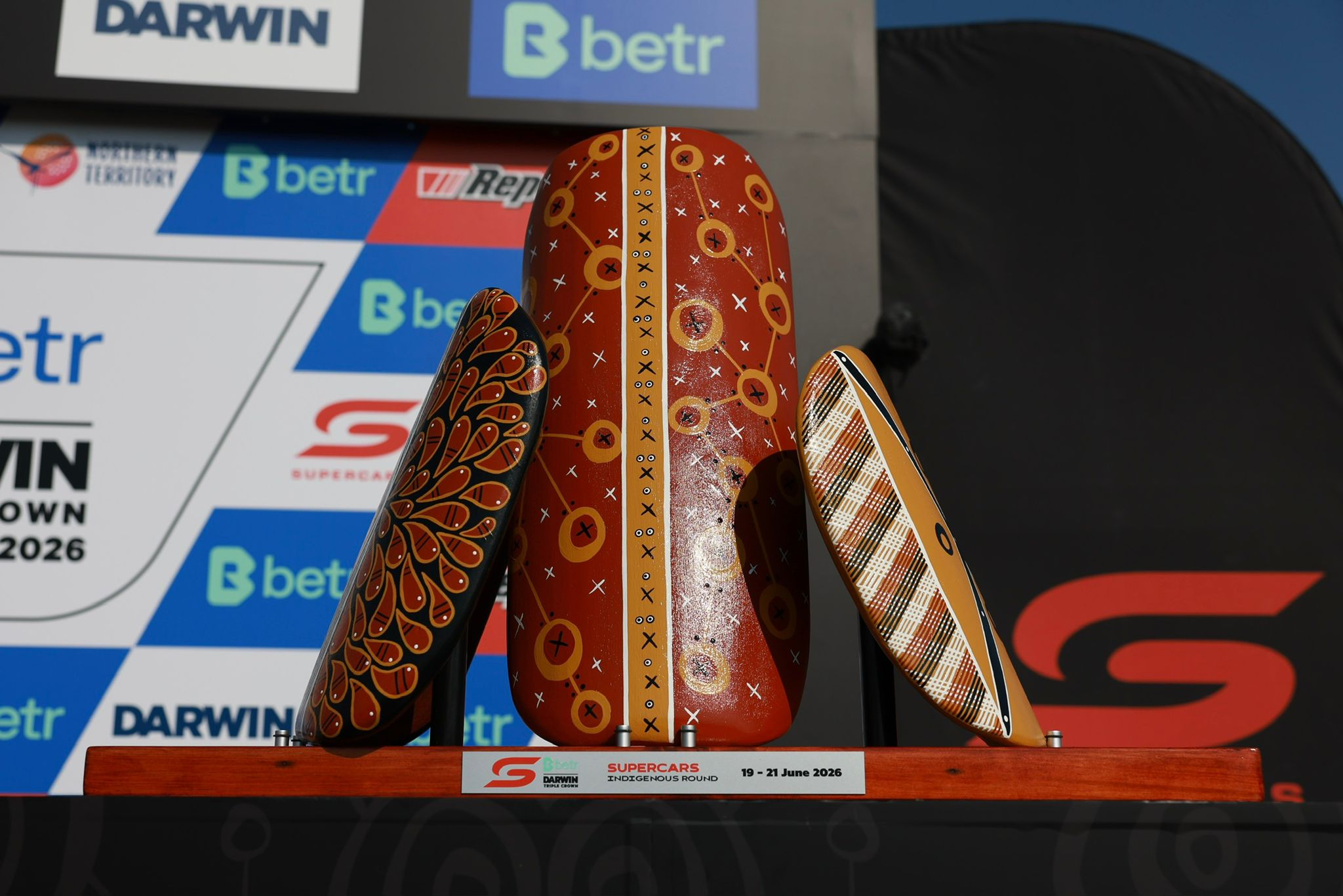 Darwin Triple Crown trophy in front of media wall at Darwin Supercars