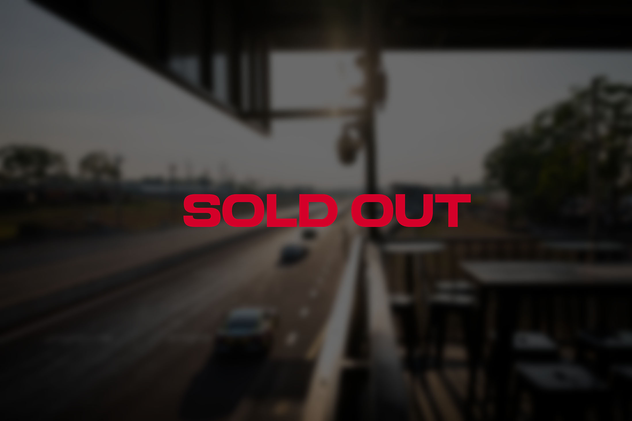 Red text SOLD OUT over an image of race cars on a track