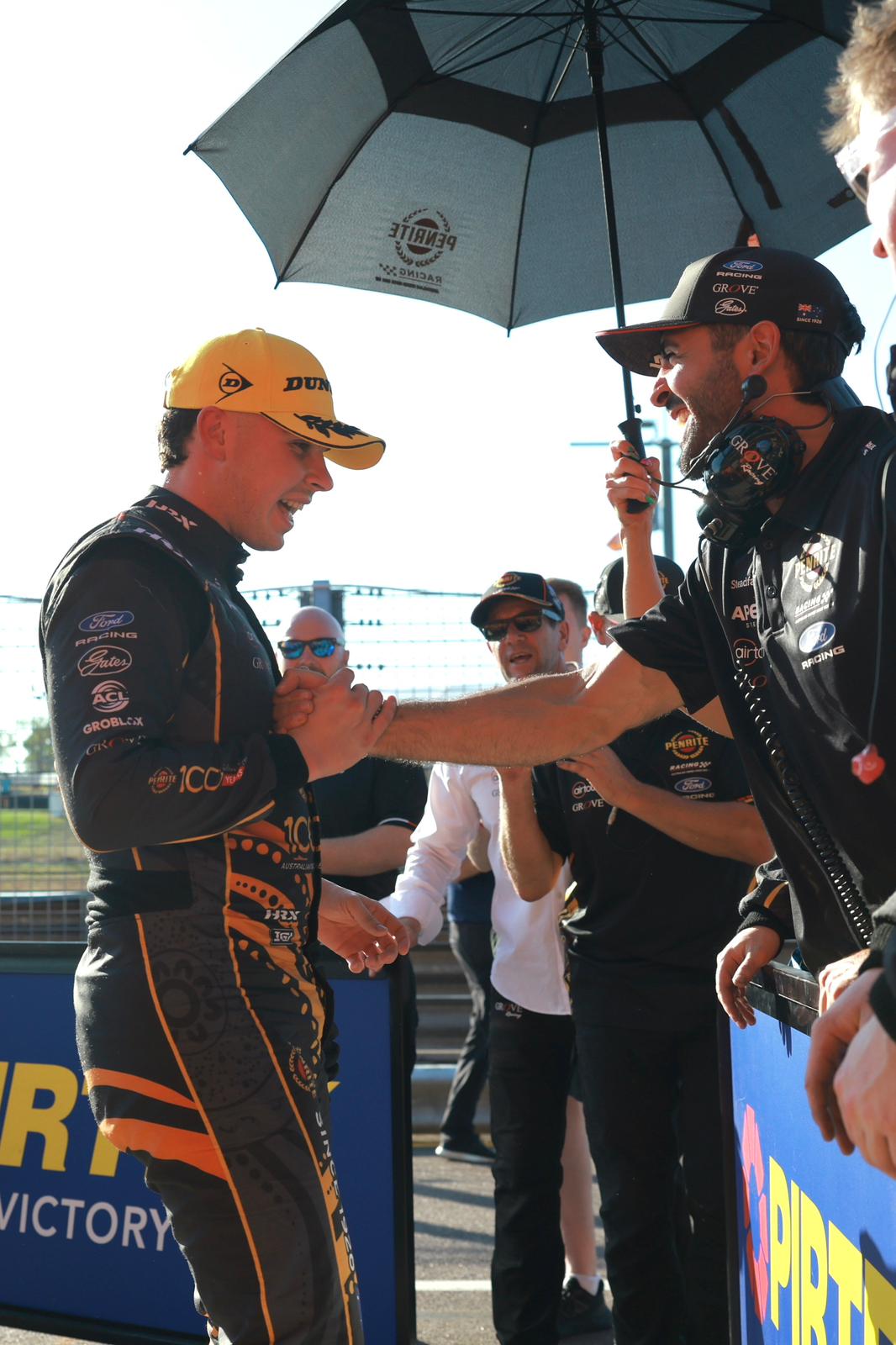 A Supercars driver celebrates with his team after a Darwin Triple Crown podium finish.