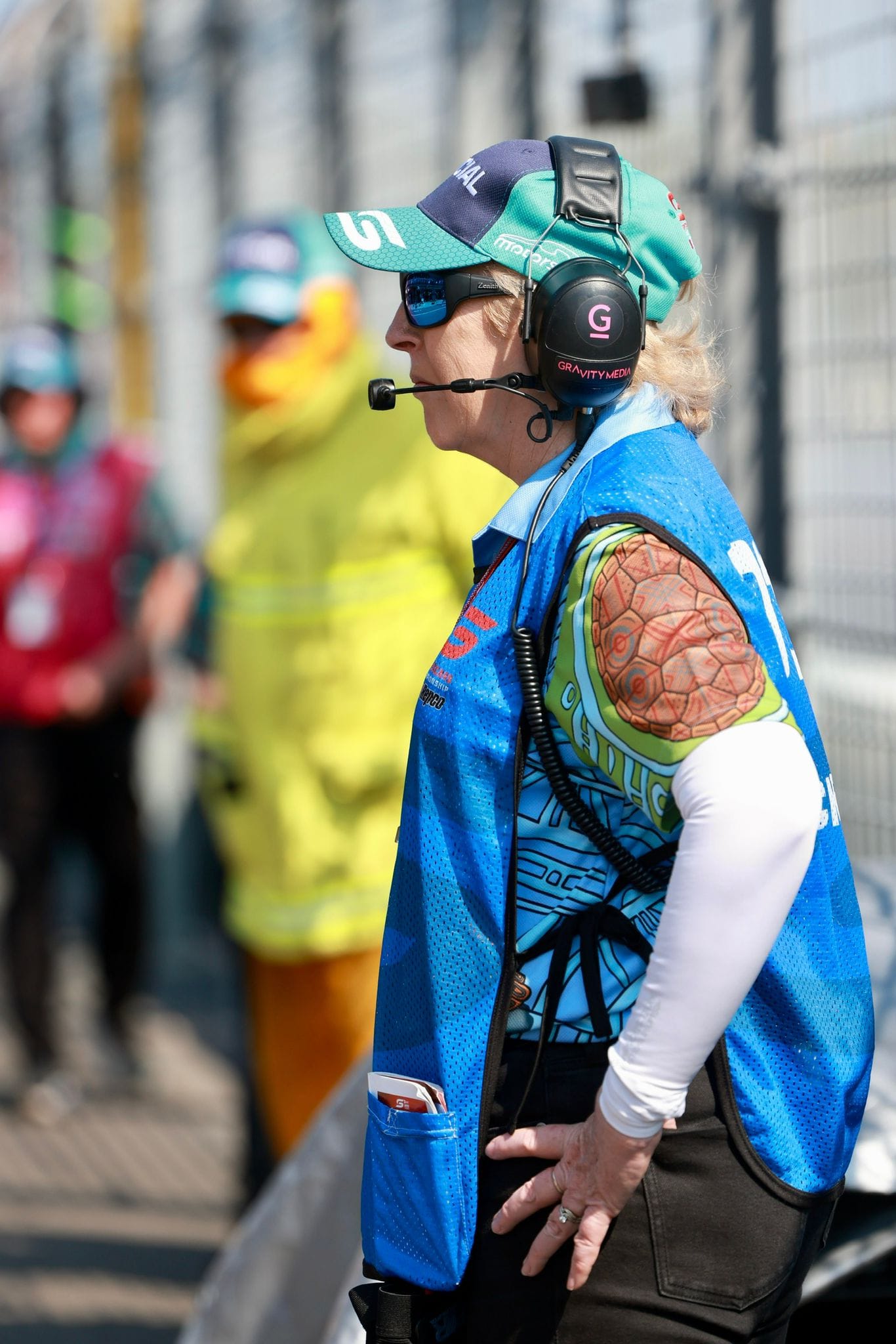 A pit lane official wearing a headset watches the track during Darwin Supercars at Hidden Valley Raceway.