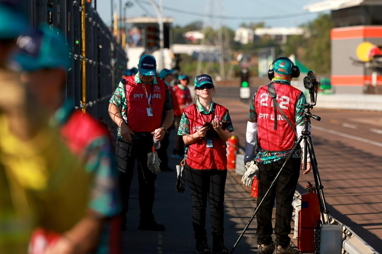 Pit lane officials walk along the Hidden Valley Raceway pit wall during Darwin Supercars.
