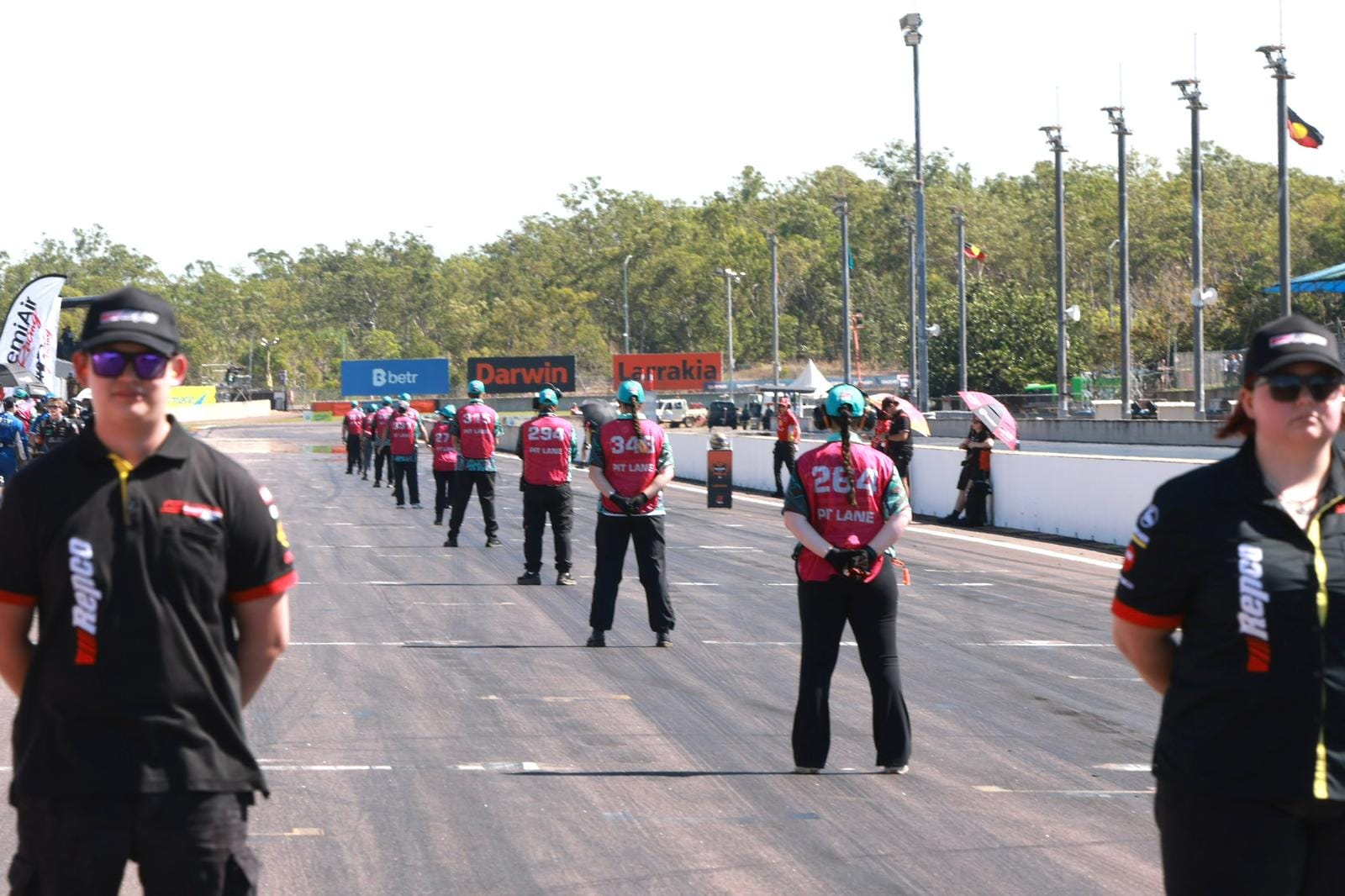 Pit lane officials stand on the main straight at Hidden Valley Raceway before the Darwin Triple Crown race.