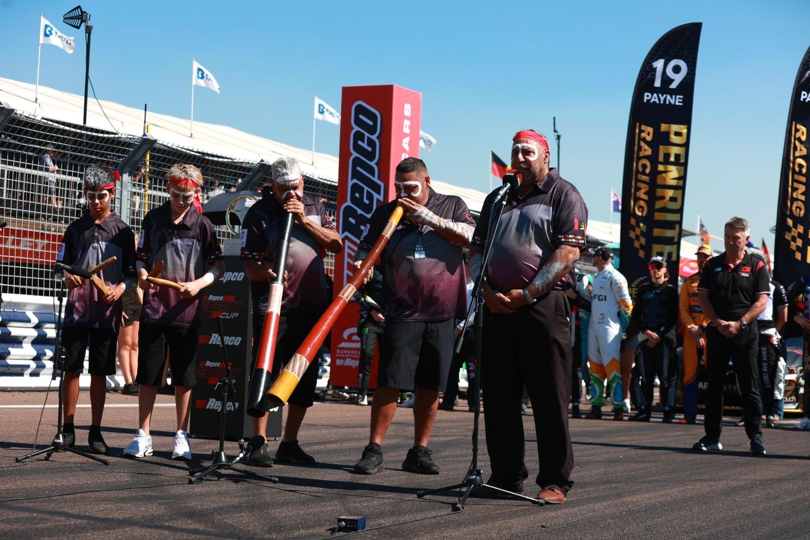 Musicians perform a didgeridoo ceremony on the grid before the Darwin Triple Crown race at Hidden Valley Raceway.