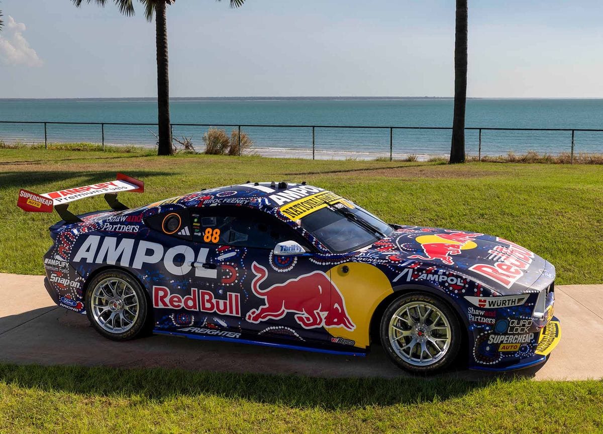 Red Bull Ampol Racing Supercar parked near the Darwin coastline with ocean views in the background.
