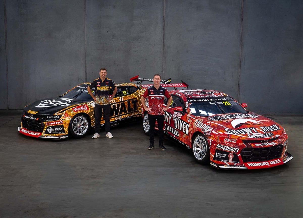 Two Team 18 drivers standing with DeWalt and Snowy River Caravans Supercars in Indigenous liveries.