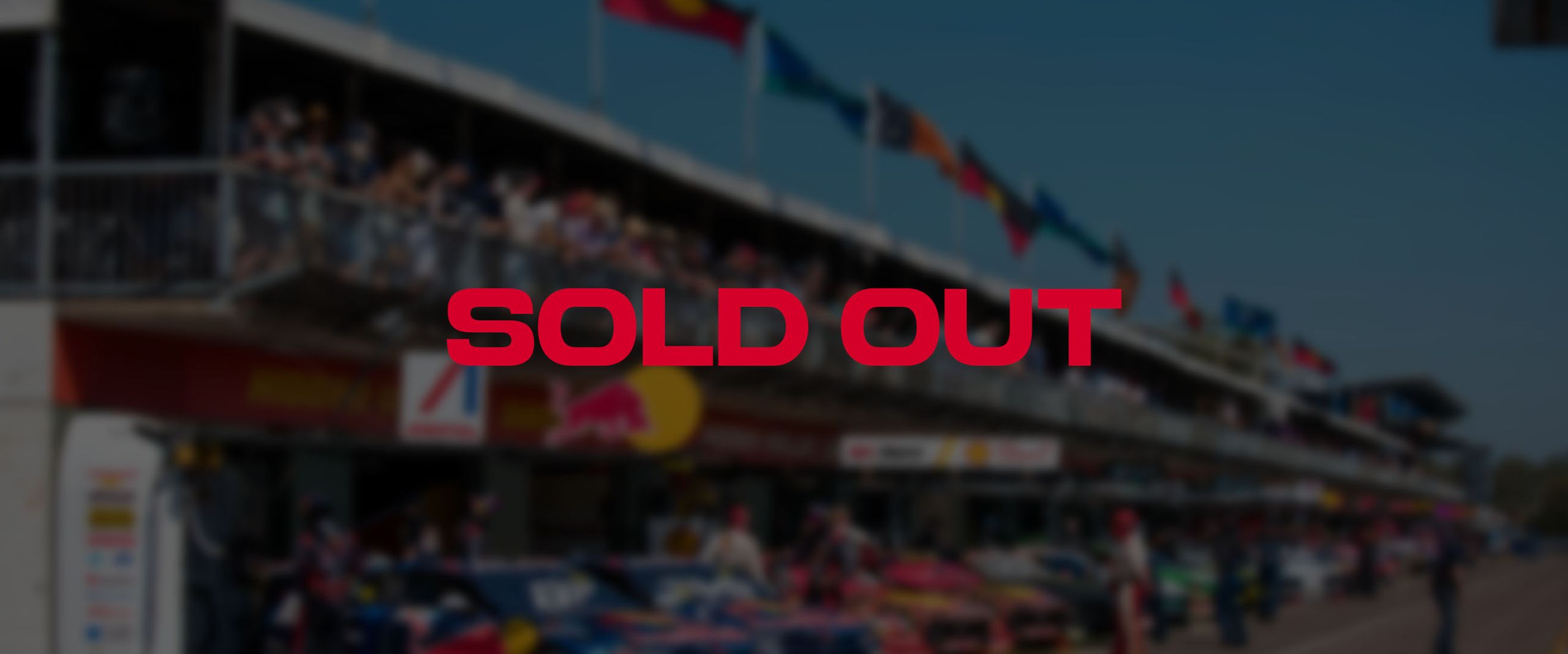 SOLD OUT in red text over a blurred image of the Darwin Supercars pit lane